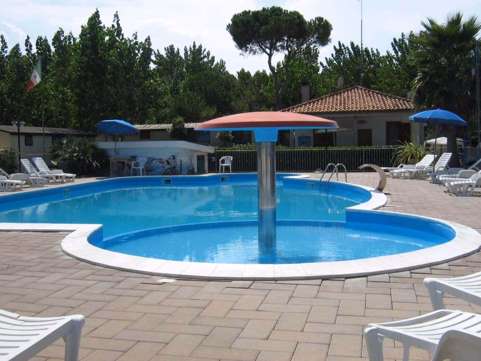 Piscina con ombrelloni, sdraio e lettini nel villaggio a Giulianova